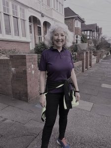 Karen, a white middle-aged woman in running gear, standing on a pavement