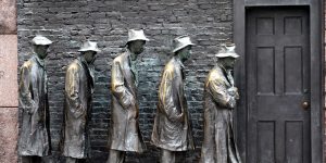 A sculpture depicting five men in Thirties garb waiting in line at a closed-door.